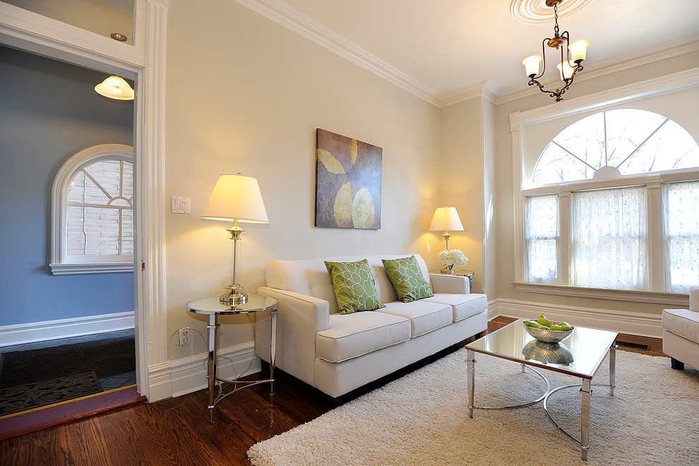 Mittelgroßes, Repräsentatives, Fernseherloses, Abgetrenntes Klassisches Wohnzimmer mit beiger Wandfarbe, braunem Holzboden, Kamin und Kaminumrandung aus Holz in Toronto