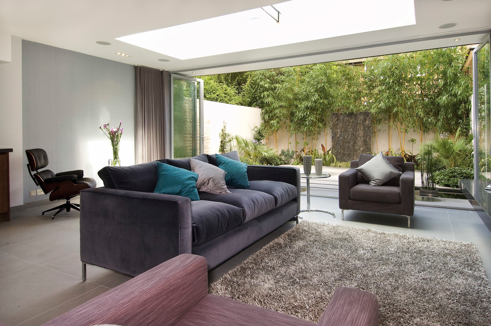 This is an example of a medium sized contemporary formal open plan living room in London with grey walls.