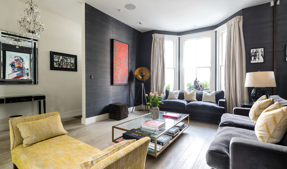 This is an example of a medium sized eclectic enclosed living room in London with black walls, light hardwood flooring and grey floors.