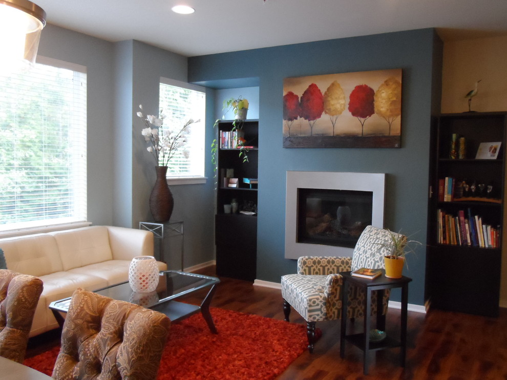 Example of a small trendy open concept medium tone wood floor living room design in Seattle with a hanging fireplace and a metal fireplace