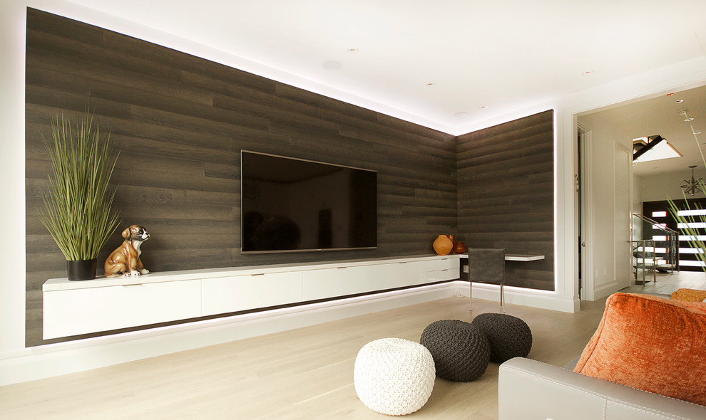 Example of a large trendy open concept light wood floor living room design in Toronto with gray walls and a wall-mounted tv