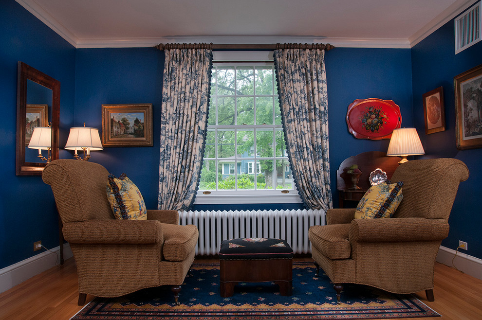 This is an example of a classic living room in Bridgeport with blue walls and light hardwood flooring.