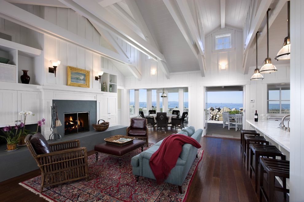 Inspiration for a large coastal open concept and formal dark wood floor living room remodel in Santa Barbara with white walls, a standard fireplace, a concrete fireplace and no tv