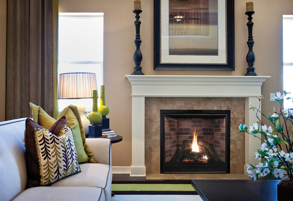 Photo of a medium sized traditional formal open plan living room in St Louis with brown walls, dark hardwood flooring, a standard fireplace, a tiled fireplace surround, no tv and brown floors.