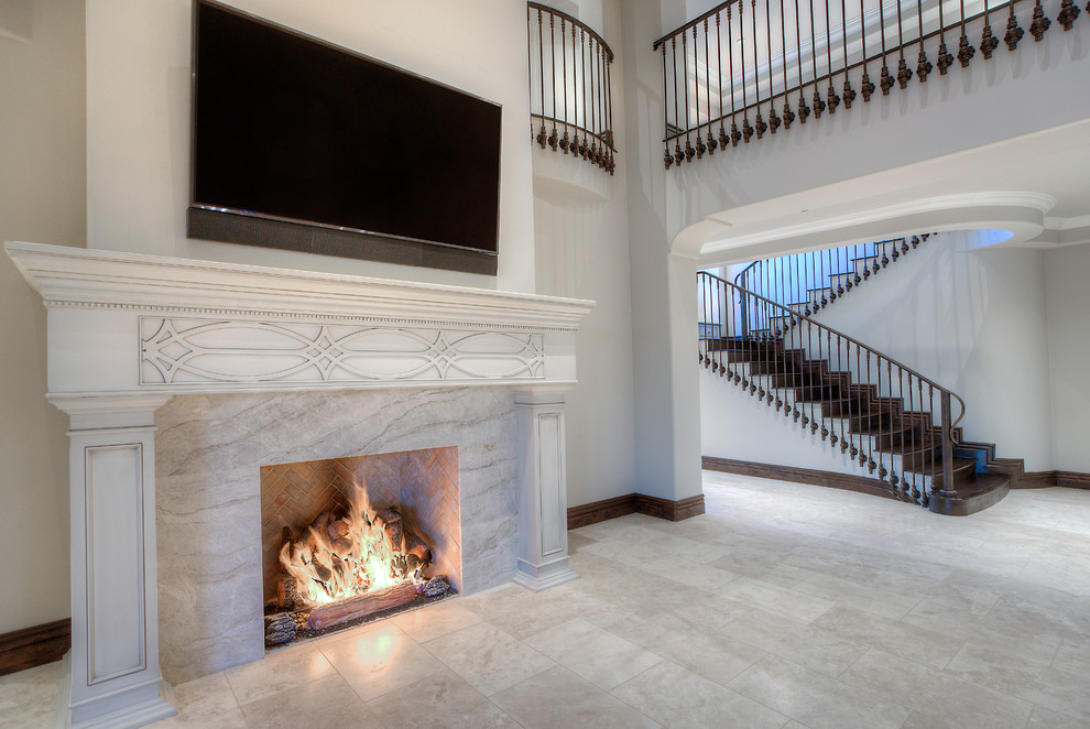 Inspiration for a huge transitional loft-style porcelain tile and white floor living room remodel in Phoenix with white walls, a standard fireplace, a tile fireplace and a wall-mounted tv