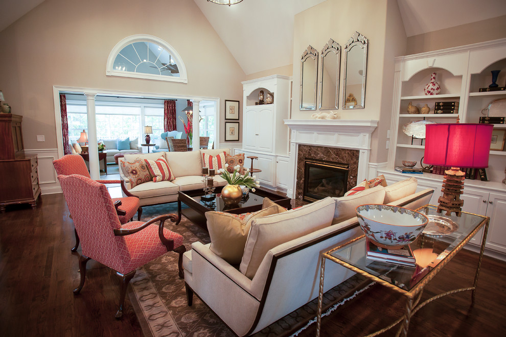 This is an example of a medium sized traditional formal open plan living room in Atlanta with beige walls, medium hardwood flooring, a standard fireplace, a concrete fireplace surround and no tv.