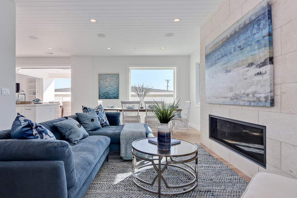 Свежая идея для дизайна: открытая гостиная комната в морском стиле с белыми стенами, светлым паркетным полом, горизонтальным камином, фасадом камина из плитки и бежевым полом - отличное фото интерьера