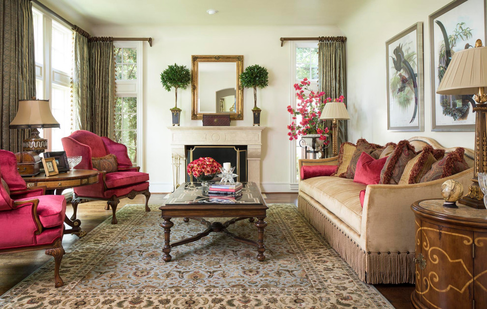 Example of a large classic enclosed medium tone wood floor and brown floor living room design in Los Angeles with a standard fireplace, a plaster fireplace and no tv