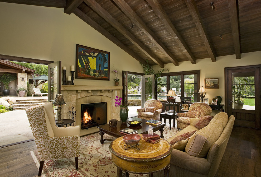 Design ideas for a traditional living room in Santa Barbara with a stone fireplace surround.