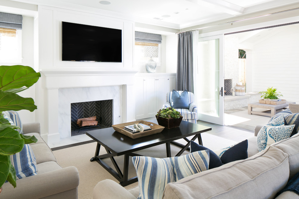 Large beach style formal open plan living room in Orange County with grey walls, medium hardwood flooring, a standard fireplace, a tiled fireplace surround and a wall mounted tv.