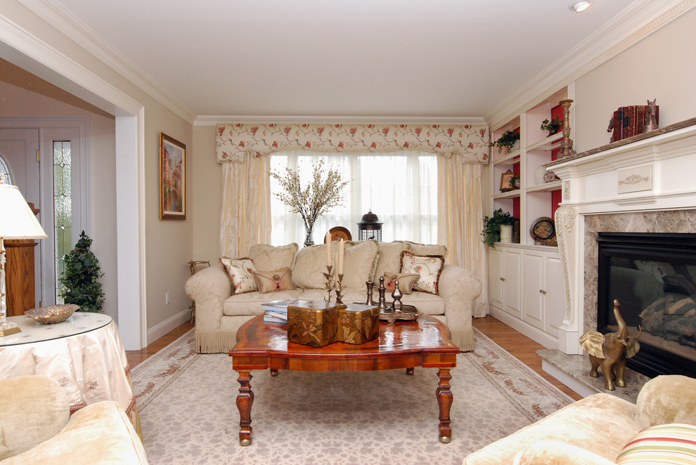 Foto di un soggiorno chic chiuso con pareti beige e camino classico