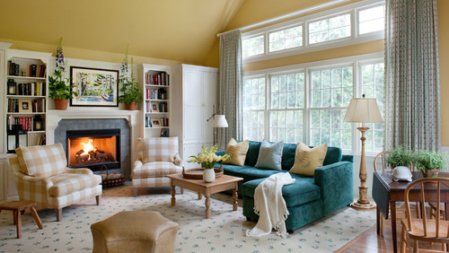 traditional living room featuring yellow walls and fireplace