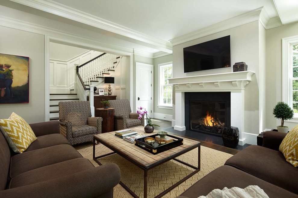 This is an example of a traditional formal living room in Minneapolis with beige walls, a standard fireplace and a wall mounted tv.