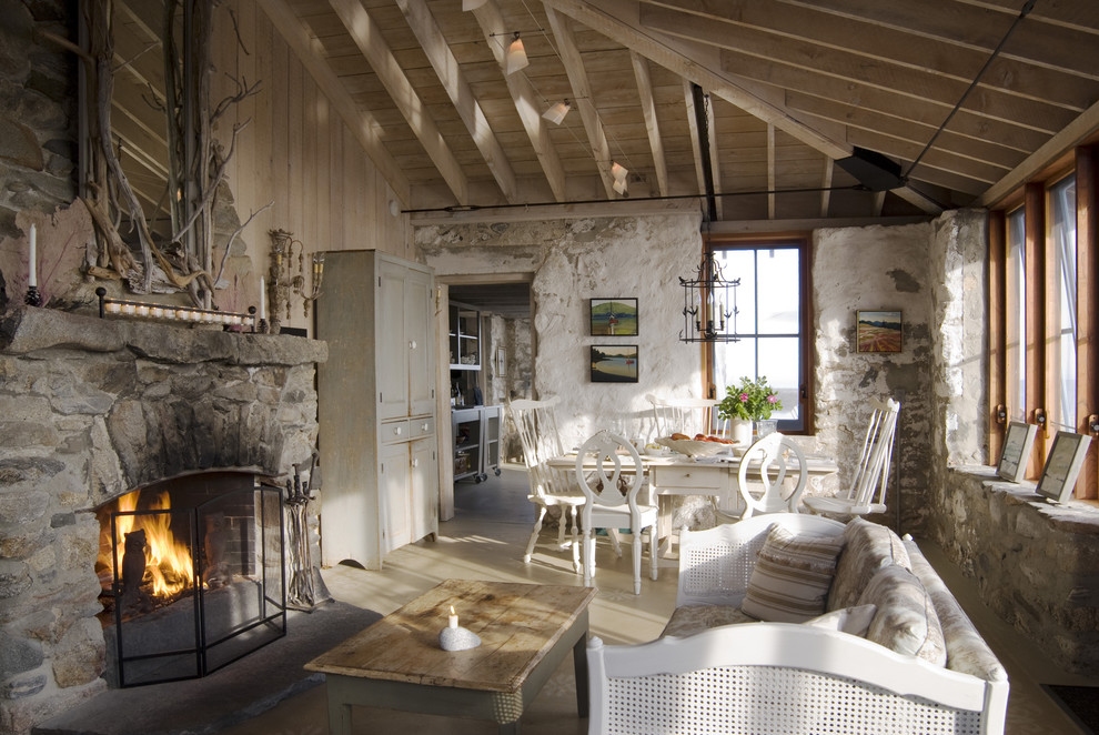 Farmhouse concrete floor living room photo in Portland Maine with a stone fireplace