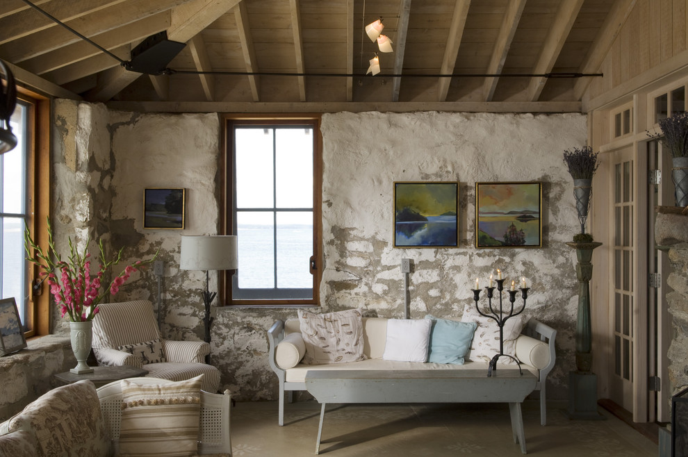 Cette photo montre un petit salon nature avec un mur en pierre et éclairage.