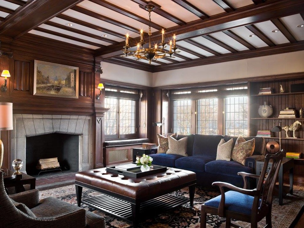Cette image montre un grand salon traditionnel fermé avec une salle de réception, une cheminée standard, un manteau de cheminée en béton, un mur beige, un sol en bois brun et aucun téléviseur.