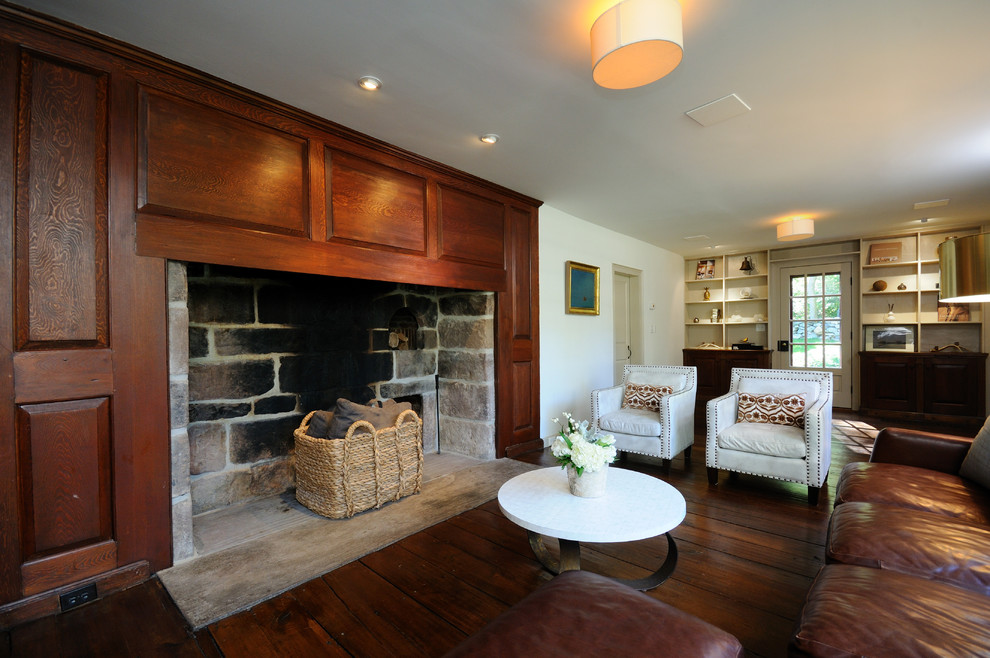 Пример оригинального дизайна: открытая гостиная комната среднего размера:: освещение в классическом стиле с темным паркетным полом, белыми стенами, стандартным камином и фасадом камина из дерева