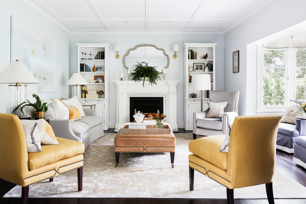 Example of a classic formal dark wood floor living room design in Sydney with a standard fireplace, a wood fireplace surround and gray walls