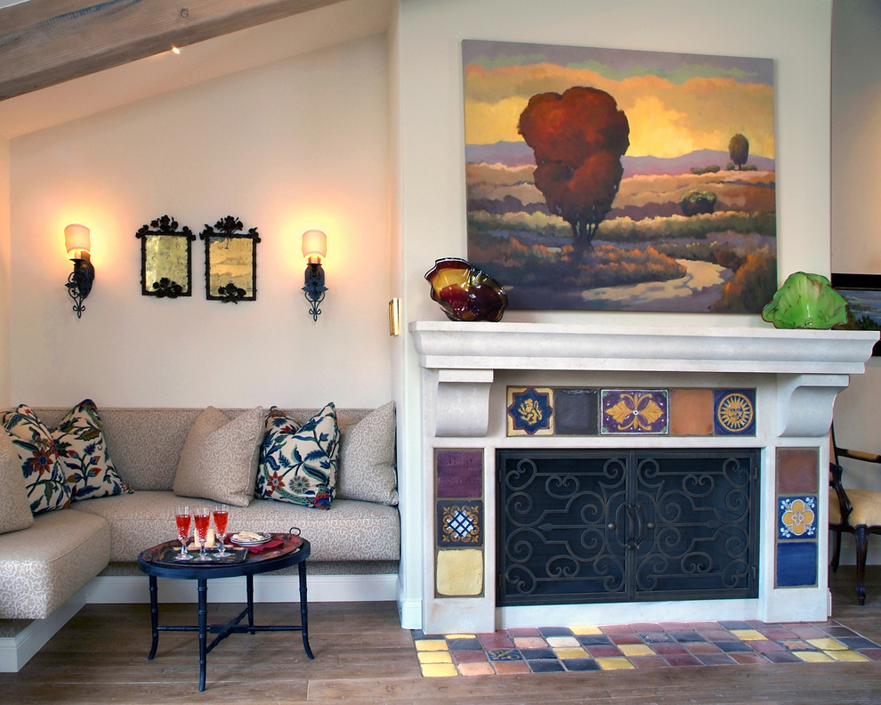 This is an example of a mediterranean living room in San Diego with beige walls and a standard fireplace.