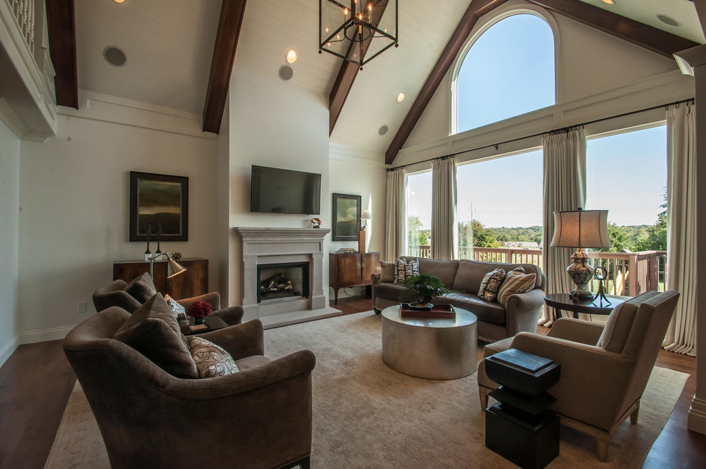 Example of a large classic open concept dark wood floor living room design in Indianapolis with white walls, a standard fireplace, a stone fireplace and a wall-mounted tv
