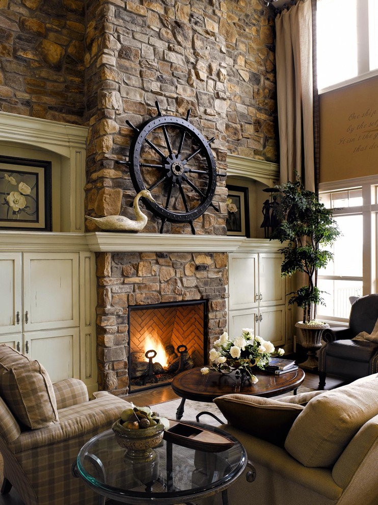Living room - coastal living room idea in San Diego with beige walls, a standard fireplace, a stone fireplace and no tv