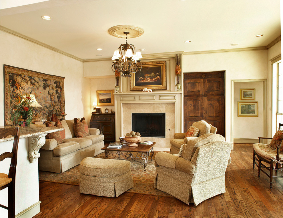 Living room - mid-sized traditional formal and open concept medium tone wood floor and brown floor living room idea in Dallas with beige walls, a standard fireplace, a tile fireplace and no tv