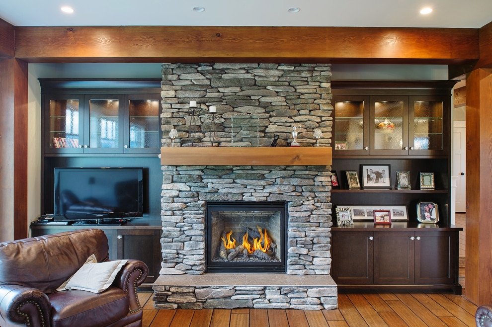 Inspiration for a mid-sized craftsman formal and open concept medium tone wood floor living room remodel in Vancouver with green walls, a standard fireplace, a stone fireplace and a tv stand