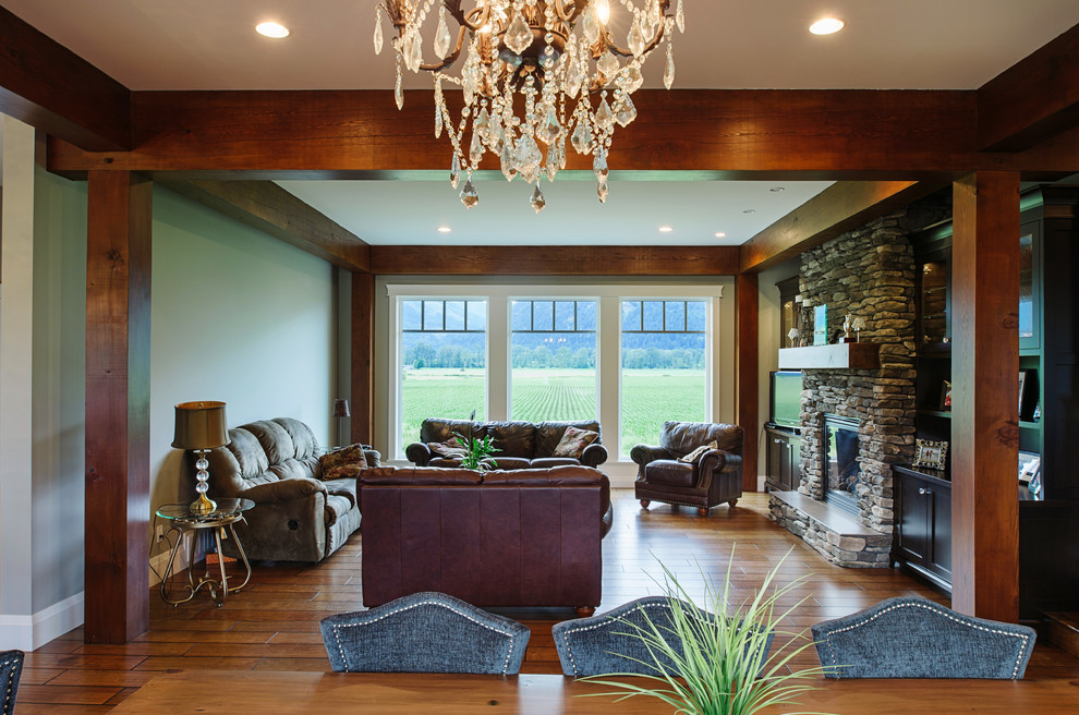Example of a mid-sized classic formal and open concept medium tone wood floor living room design in Vancouver with green walls, a standard fireplace, a stone fireplace and a tv stand