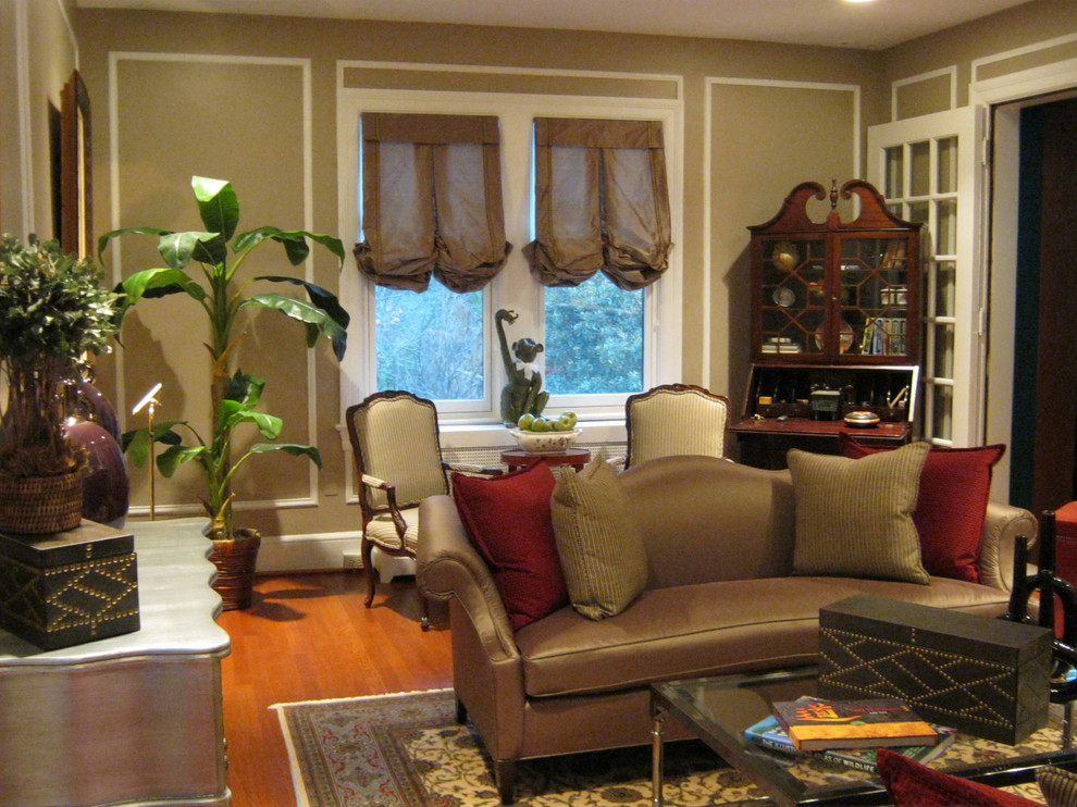 This is an example of a large traditional open plan living room in DC Metro with brown walls and medium hardwood flooring.