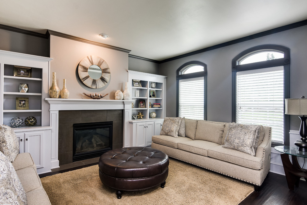 This is an example of an expansive classic formal and grey and brown enclosed living room feature wall in Portland with grey walls, dark hardwood flooring, a standard fireplace, a tiled fireplace surround, brown floors and wainscoting.