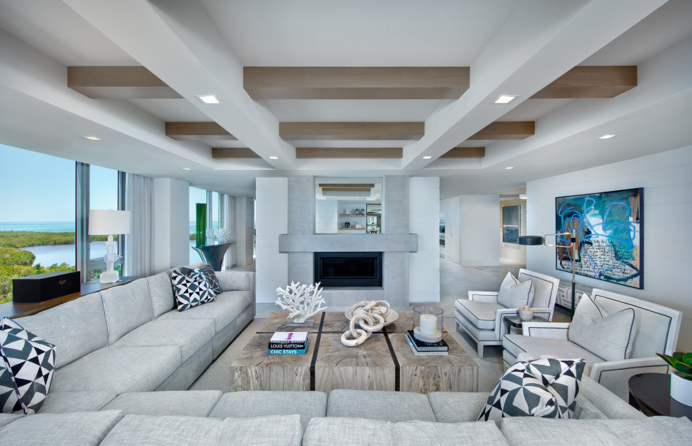 Photo of a nautical open plan living room in Miami with white walls, light hardwood flooring, a ribbon fireplace and beige floors.