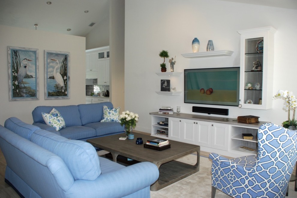 Example of a large transitional open concept porcelain tile and gray floor living room design in Miami with white walls and a wall-mounted tv