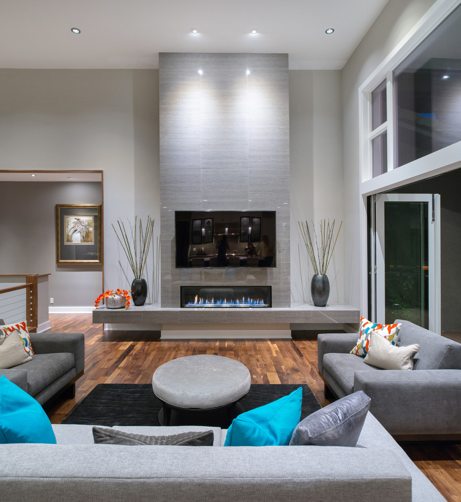 Inspiration for an expansive modern living room in Kansas City with grey walls, dark hardwood flooring and a tiled fireplace surround.
