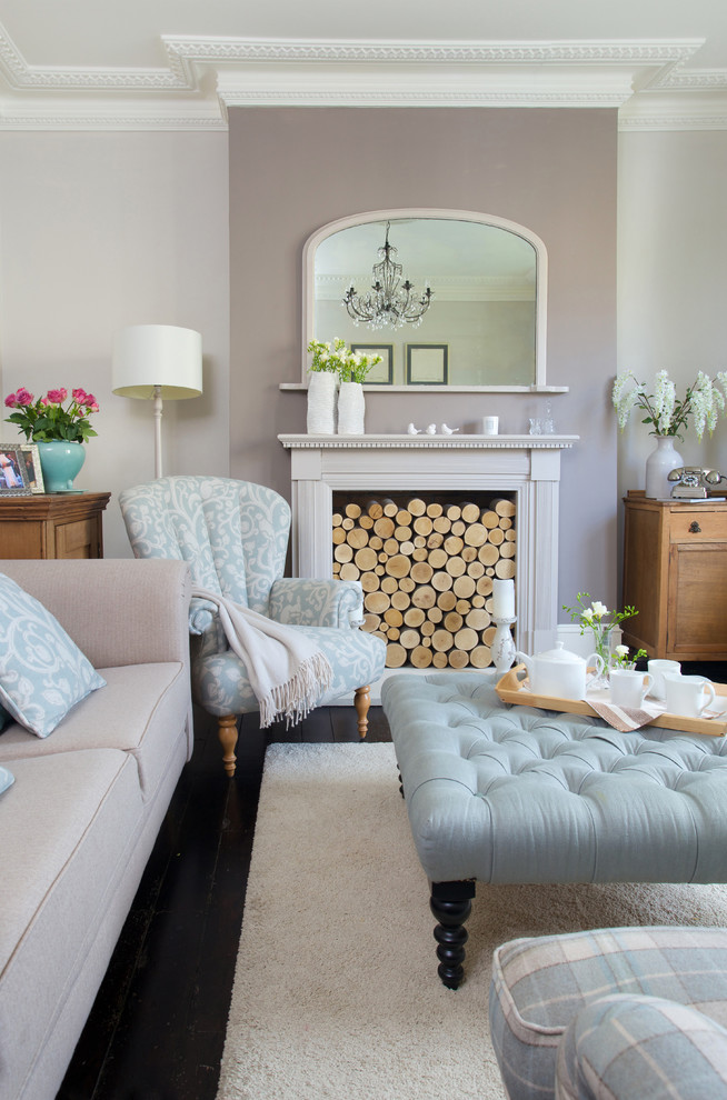 Living room - small transitional enclosed dark wood floor living room idea in London with a standard fireplace, no tv and gray walls