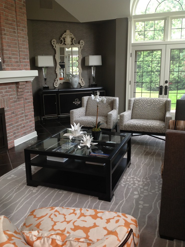Example of a mid-sized trendy enclosed porcelain tile living room library design in Milwaukee with gray walls, a standard fireplace, a brick fireplace and no tv