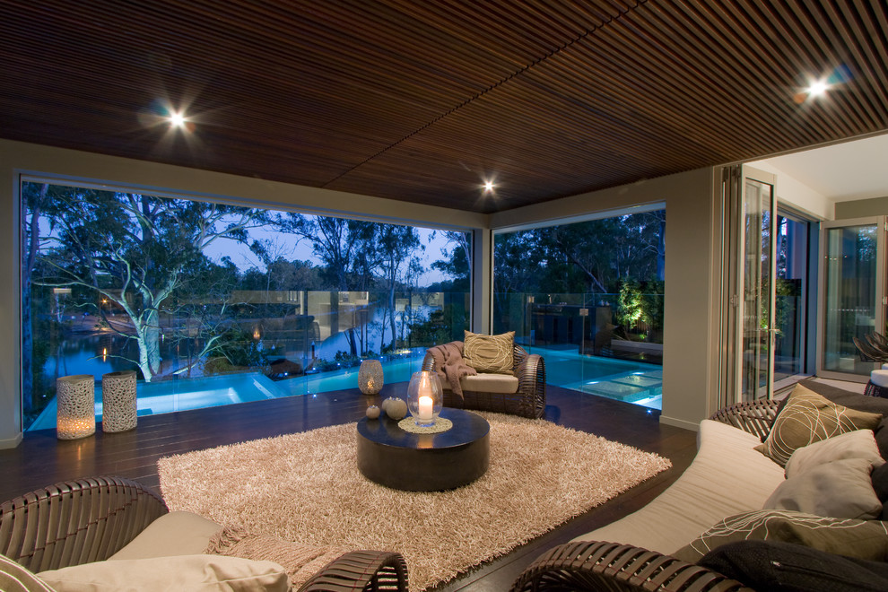 This is an example of a large classic open plan living room in Brisbane with beige walls.