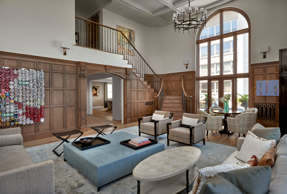 This is an example of an expansive classic living room in Chicago with light hardwood flooring, a coffered ceiling, panelled walls, wood walls, white walls and beige floors.