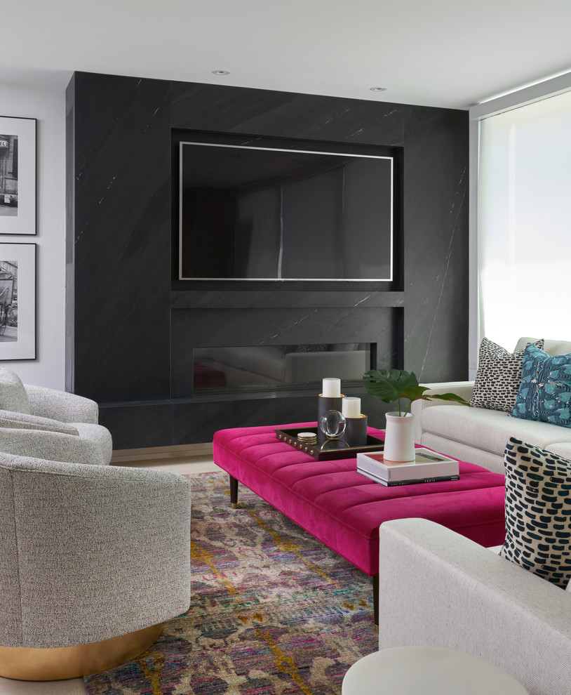 Inspiration for a transitional living room remodel in Toronto with black walls, a ribbon fireplace, a stone fireplace and a wall-mounted tv