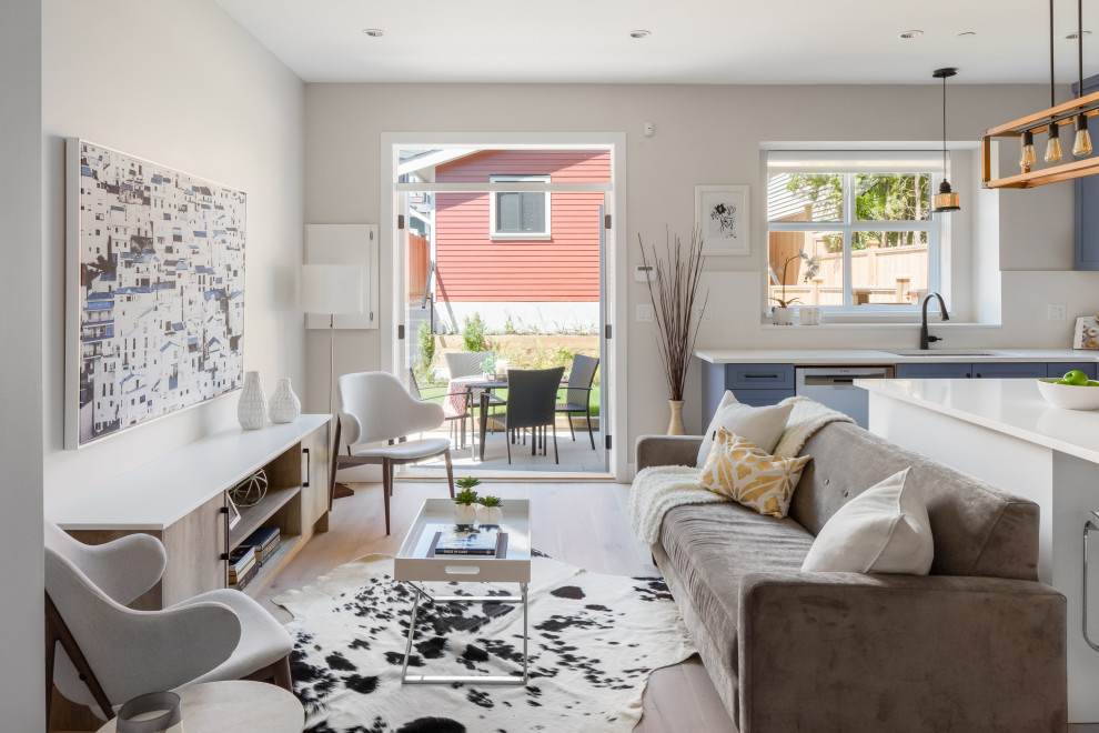 Offenes Klassisches Wohnzimmer mit weißer Wandfarbe, hellem Holzboden und beigem Boden in Vancouver