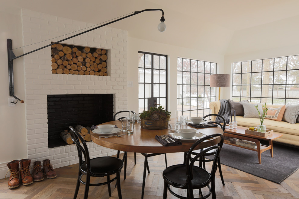 Idée de décoration pour un salon tradition avec un mur blanc, un sol en bois brun et un manteau de cheminée en brique.