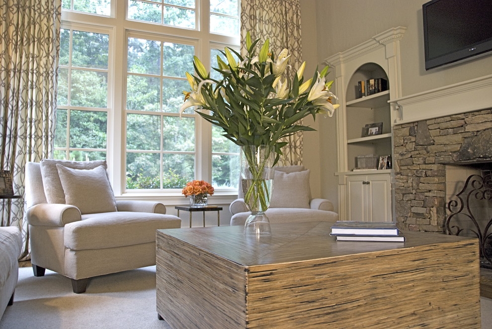 Example of a mid-sized transitional open concept medium tone wood floor and brown floor living room design in Atlanta with beige walls, a wall-mounted tv, a standard fireplace and a stone fireplace