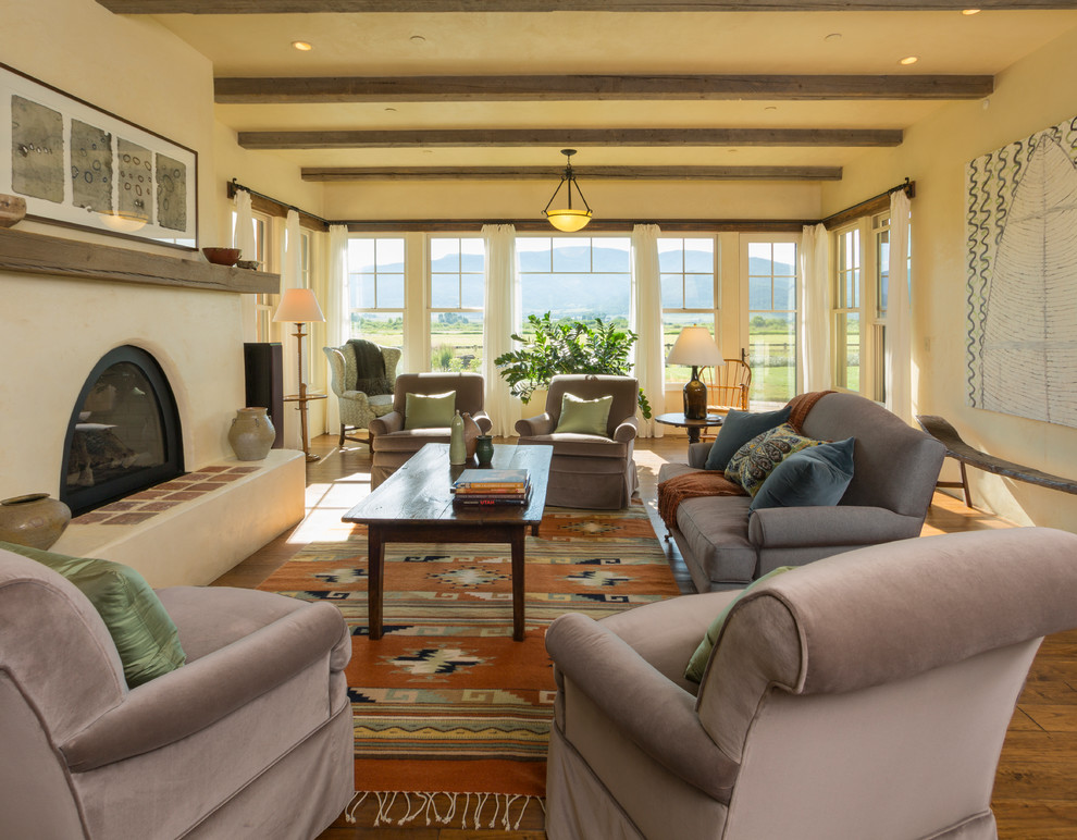 This is an example of a large living room in Denver with beige walls.