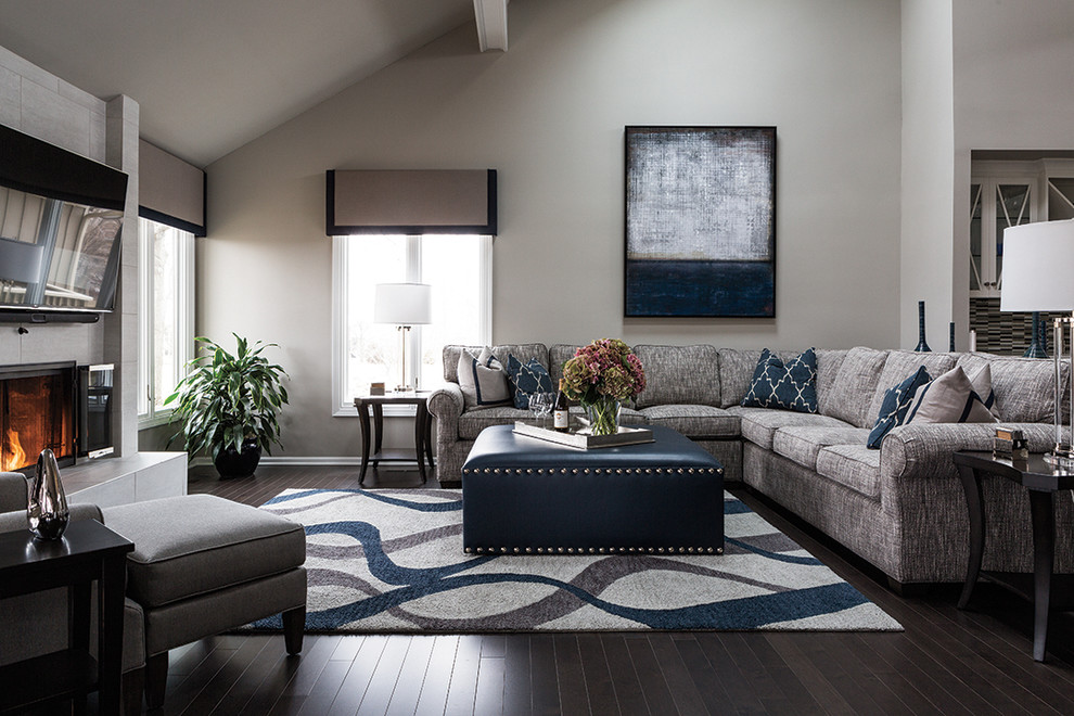 Large transitional formal and open concept dark wood floor living room photo in Kansas City with gray walls, a standard fireplace, a tile fireplace and a wall-mounted tv