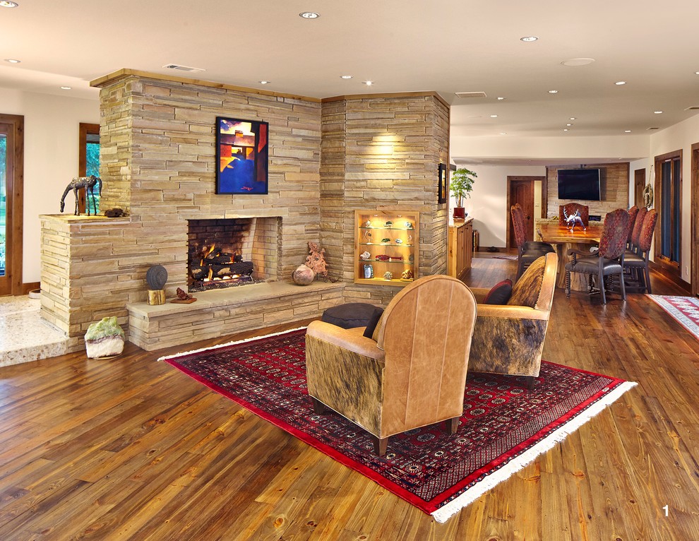 Living room - mid-sized rustic formal and open concept medium tone wood floor living room idea in Dallas with beige walls, a standard fireplace, a stone fireplace and no tv