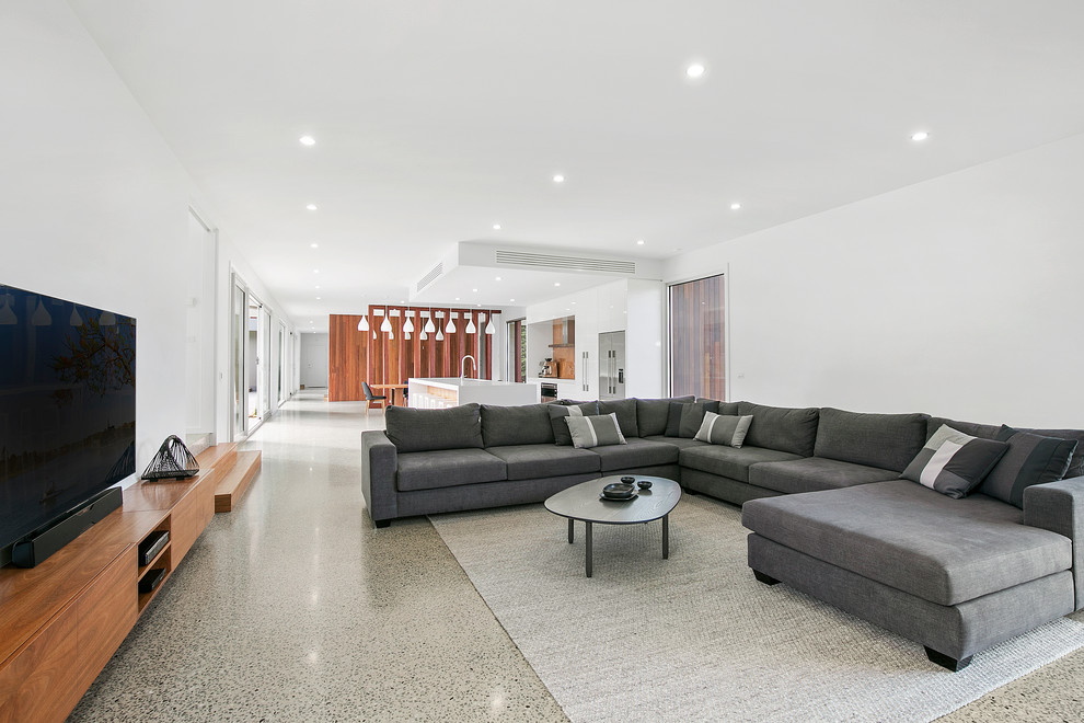 This is an example of an expansive contemporary open plan living room in Geelong with white walls.