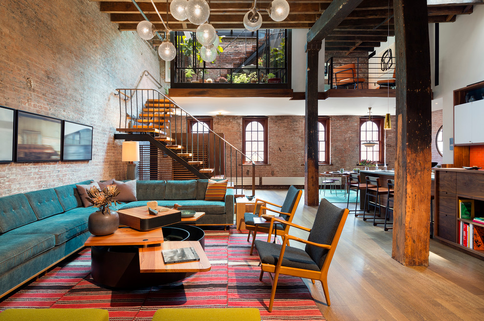 Design ideas for an industrial formal open plan living room in New York with medium hardwood flooring.
