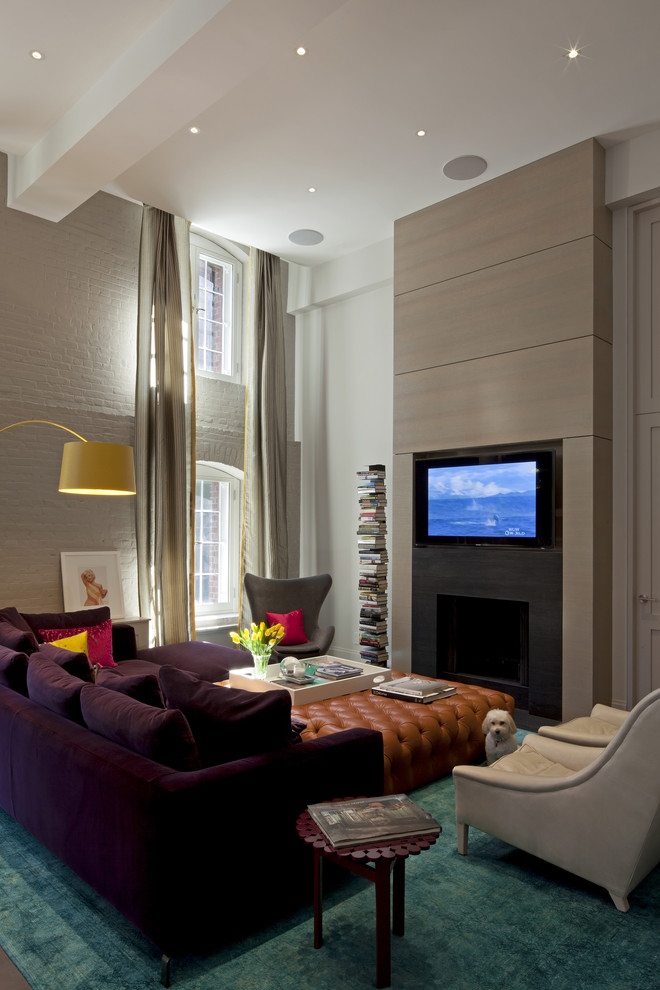 Example of a trendy living room design in New York with a standard fireplace and a wall-mounted tv