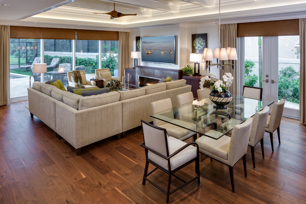 This is an example of a world-inspired living room in Miami with a wall mounted tv, a ribbon fireplace, dark hardwood flooring and a tiled fireplace surround.