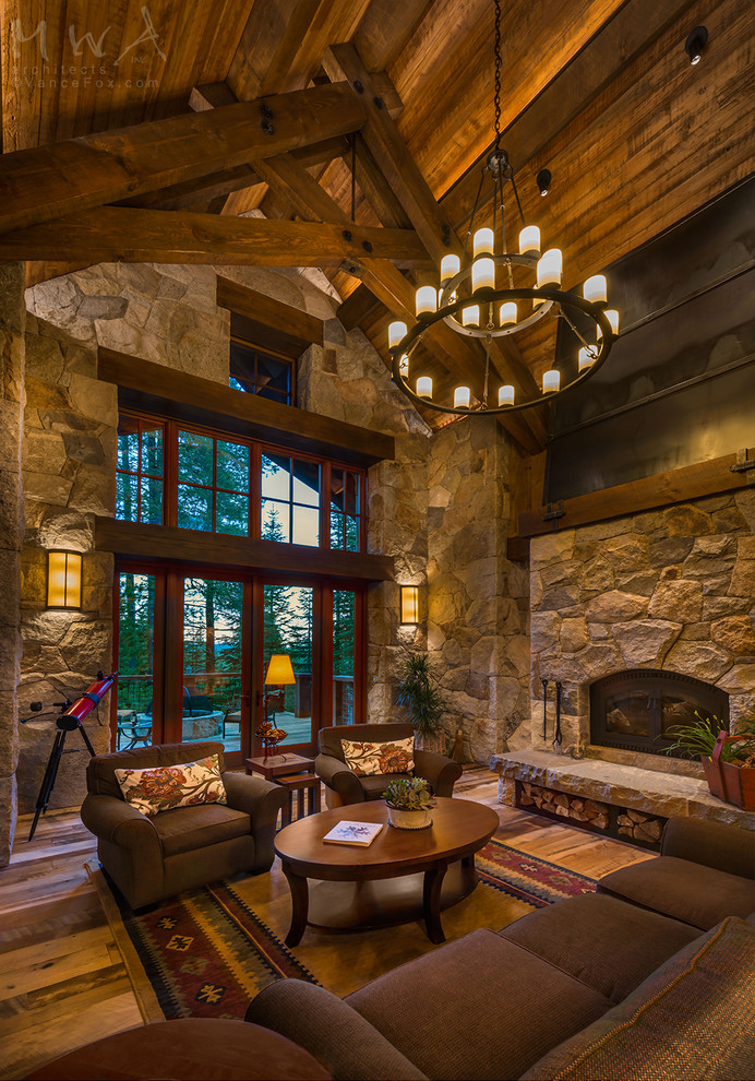 Inspiration for a mid-sized craftsman open concept and formal medium tone wood floor and brown floor living room remodel in Other with a standard fireplace, a stone fireplace and brown walls