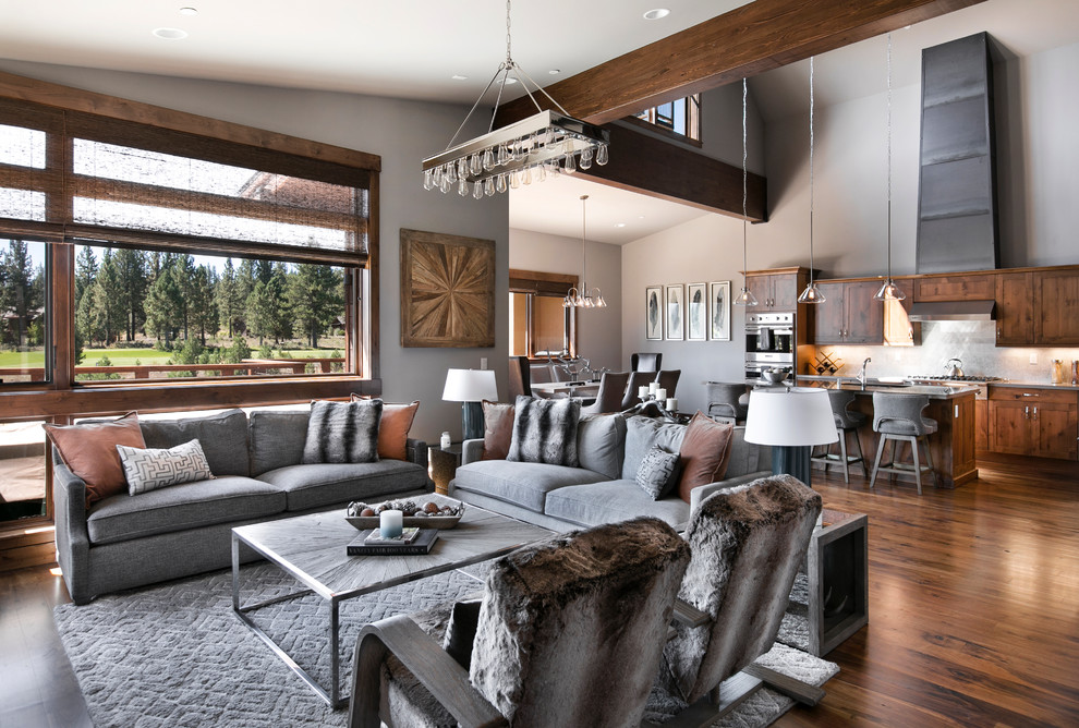 Large rustic open plan living room in Sacramento with grey walls and medium hardwood flooring.